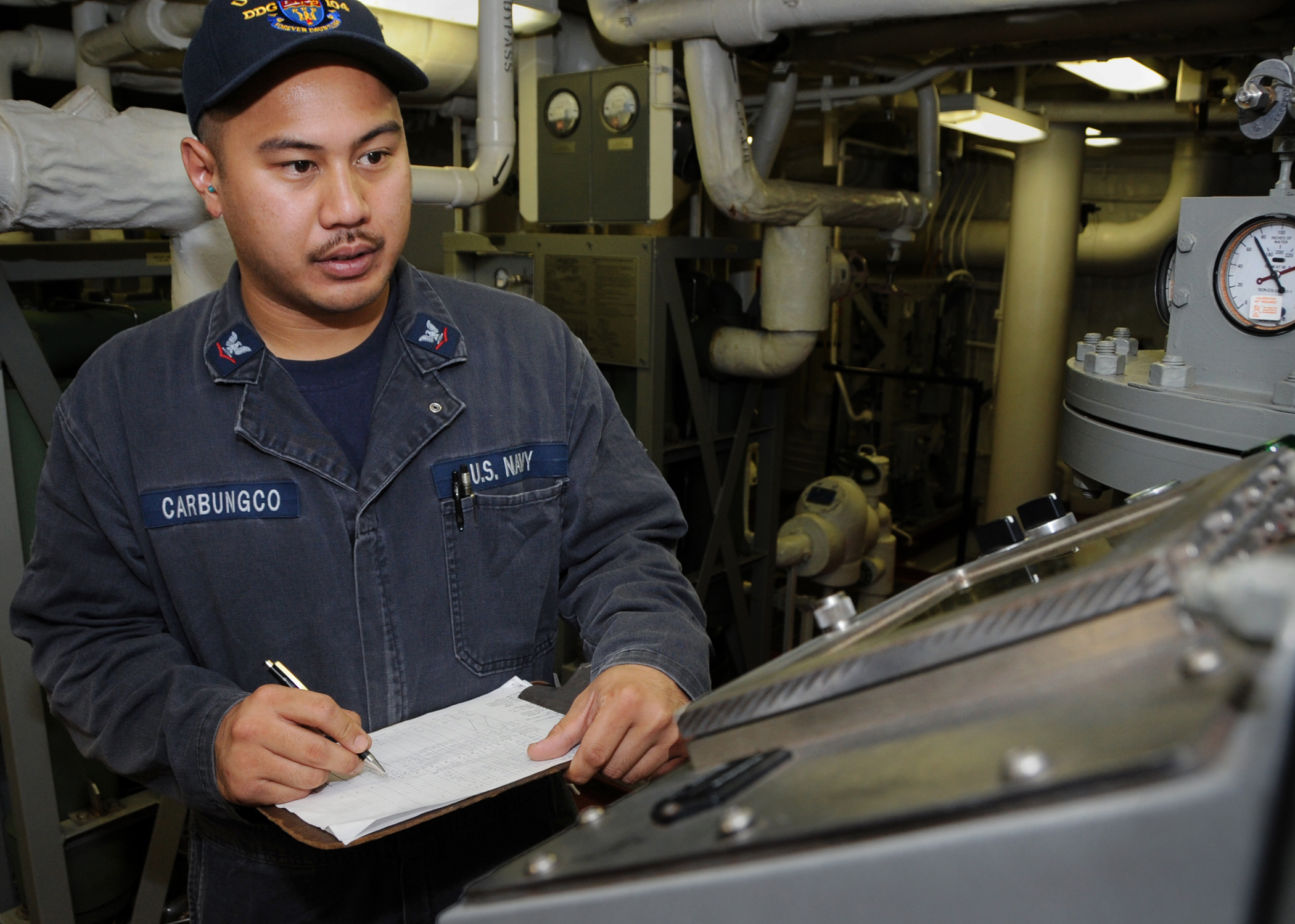 Flickr - Official U.S. Navy Imagery - USS Sterett Sailor takes equipment readings in ship's engine room.
