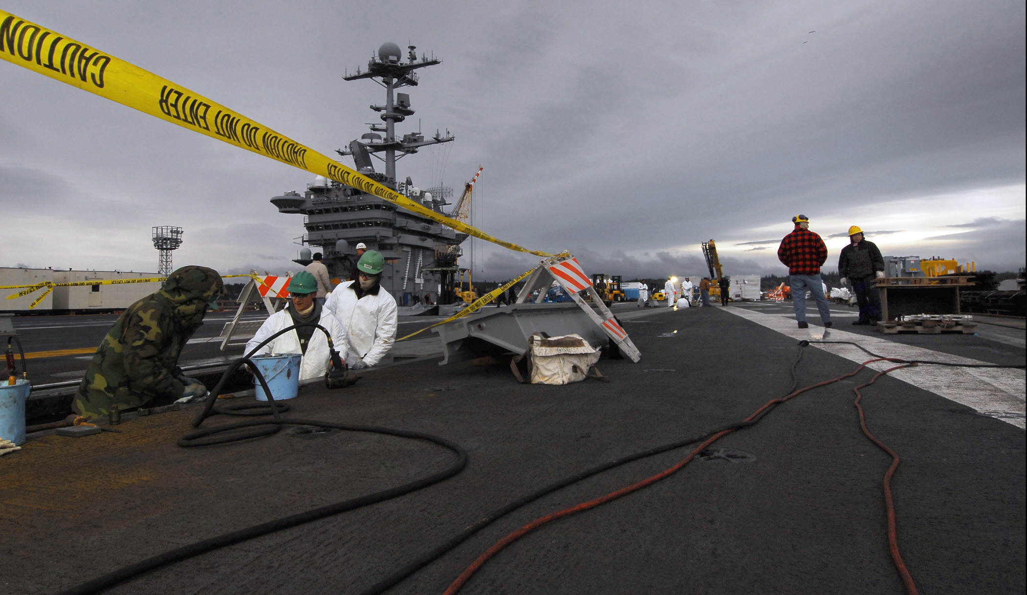 US Navy 080208-N-6538W-019 Civilian yard workers from Puget Sound Naval Shipyard perform maintenance on the bow catapults of the …