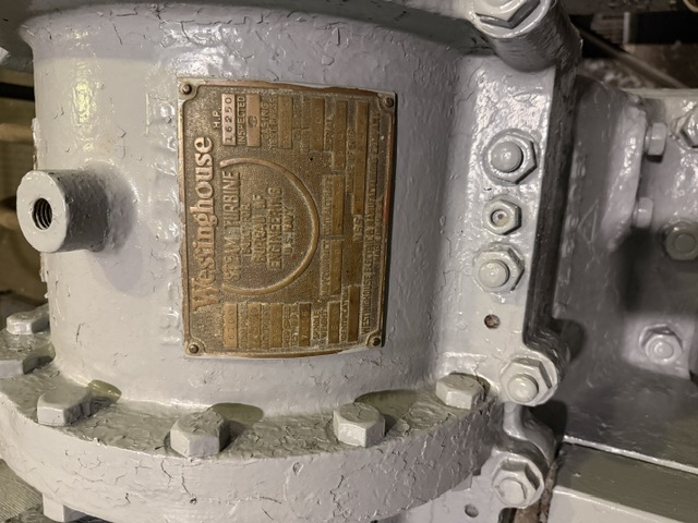 Westinghouse builder's nameplate documented aboard USS Alabama (BB-60) — Close-up of the brass Westinghouse builder's plate on a 16,250 H.P. steam turbine built in 1939 for the U.S. Navy Bureau of Engineering, mounted on its gray-painted casing aboard USS Alabama.