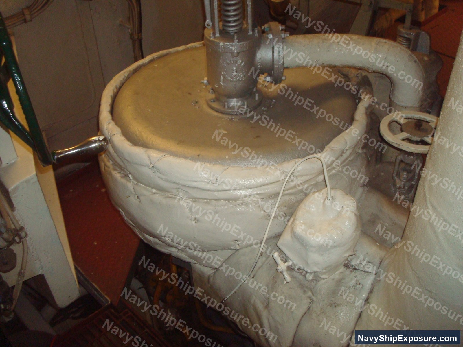 USS Midway — Engine room or machinery space equipment from USS Midway showing a large cylindrical vessel with insulation wrapping and connected piping systems typical of naval steam propulsion systems.