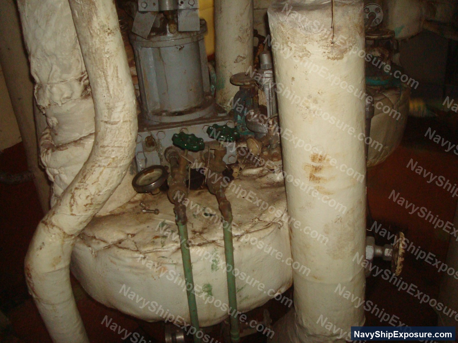 USS Midway — Engine room or machinery space aboard USS Midway showing insulated piping, valves, and mechanical equipment typical of a 1940s-era aircraft carrier's propulsion system.