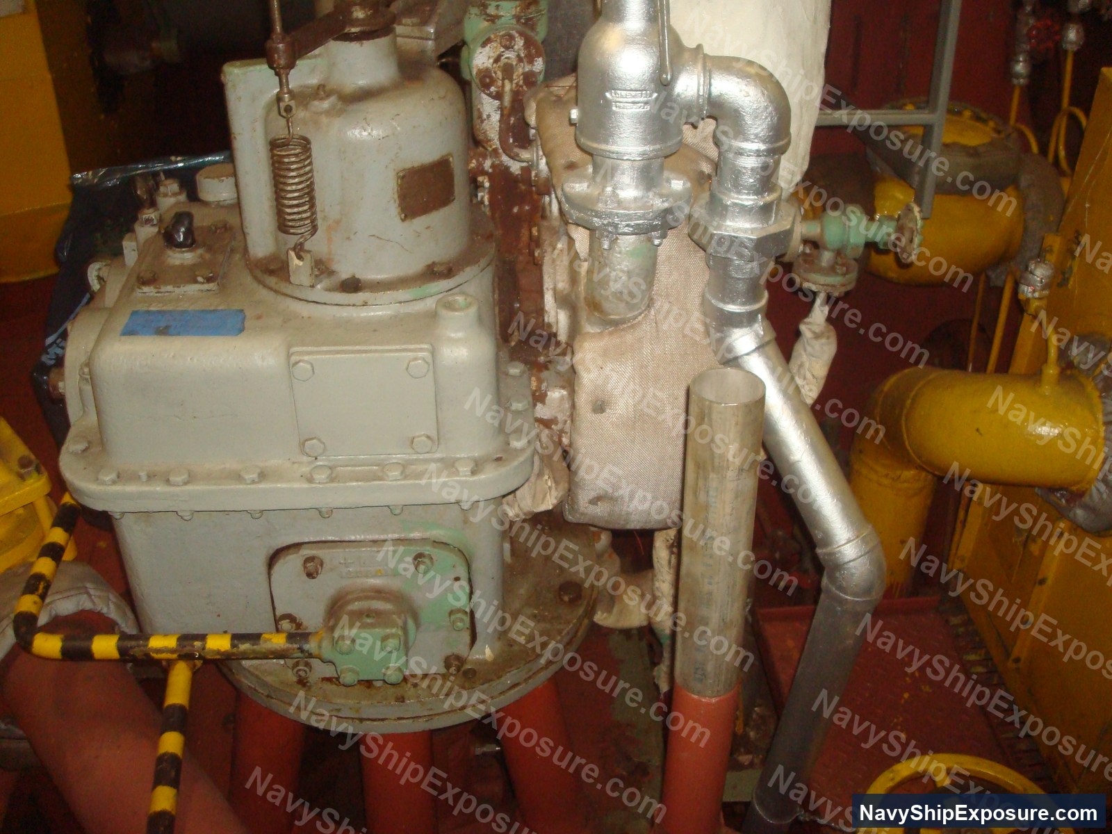USS Midway — Engine room or machinery space equipment from USS Midway showing vintage industrial pumps, piping systems, and mechanical components typical of 1940s-era naval vessel propulsion systems.
