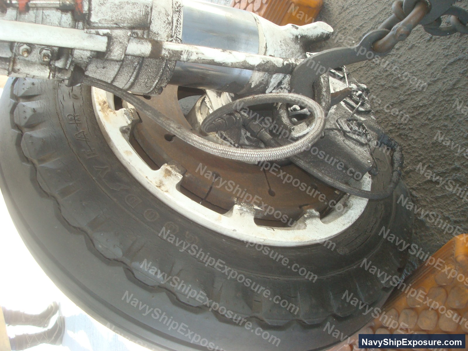 USS Midway — Close-up photograph of a ship's brake assembly or brake drum component with insulation wrapping and mechanical linkages, typical of machinery space equipment from the USS Midway era.