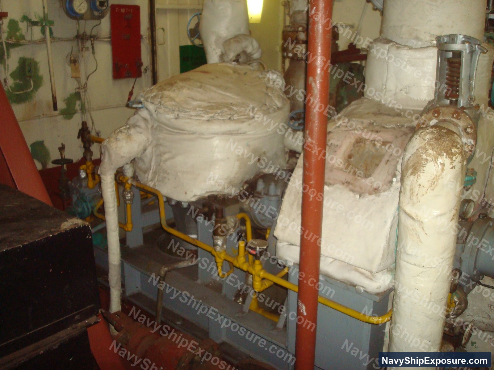 USS Midway — Boiler room machinery space aboard USS Midway showing large cylindrical boilers with insulation wrapping and yellow safety railings.