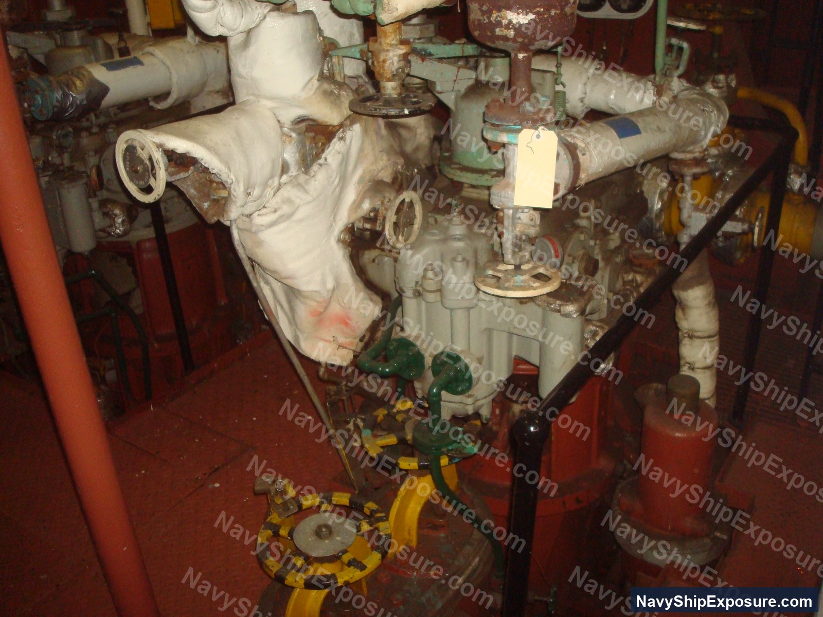 USS Midway — Engine room machinery space aboard USS Midway showing wrapped piping, valves, and industrial equipment typical of 1940s-era naval propulsion systems.