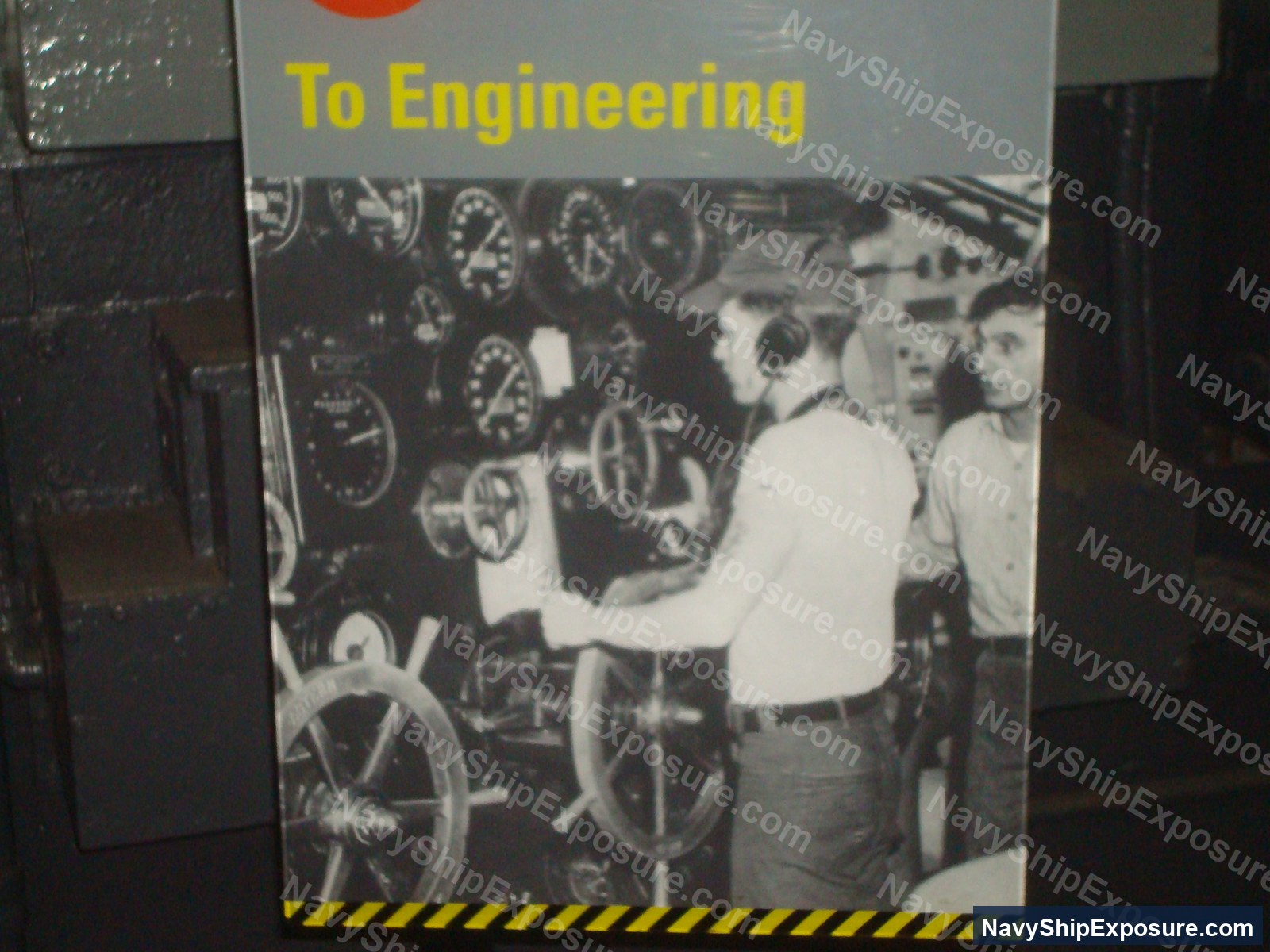USS Midway — Historical black and white photograph showing engineering personnel operating machinery controls and gauges in an engine room or machinery space aboard USS Midway, typical of 1940s-era naval vessel propulsion systems that commonly contained asbestos insulation.