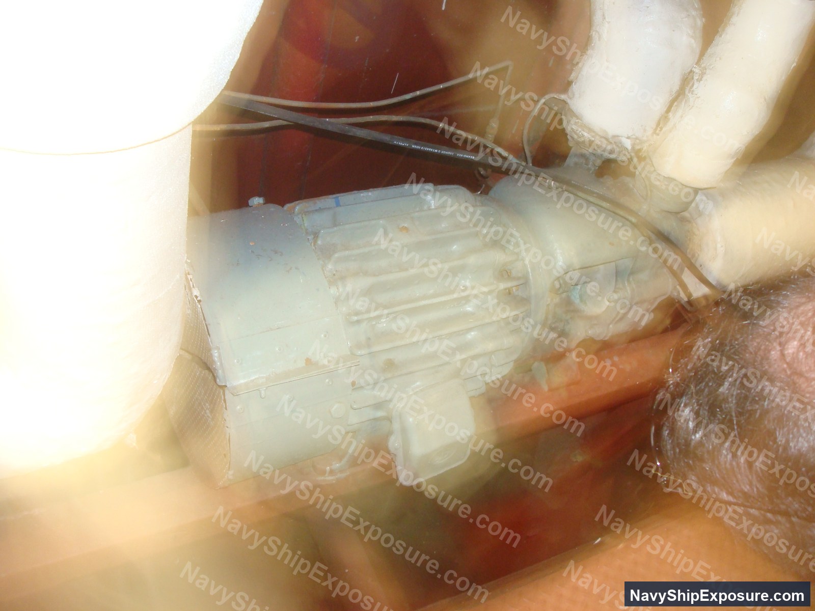 USS Midway — Close-up photograph of what appears to be an electric motor or pump component with visible wiring, likely from the USS Midway's machinery spaces.