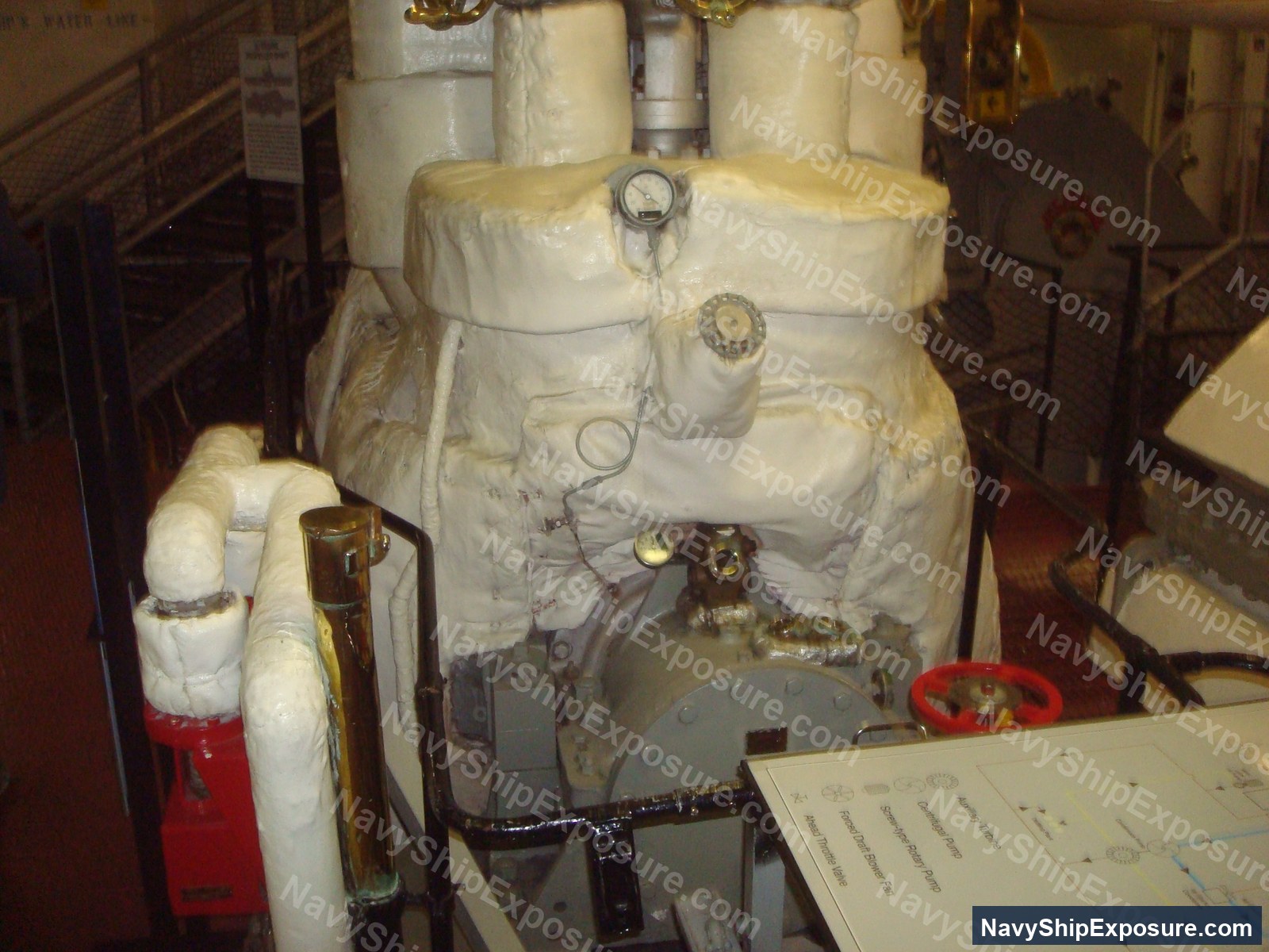 USS Midway — Engine room or machinery space aboard USS Midway showing wrapped piping, valves, gauges, and industrial equipment typical of 1940s-era naval propulsion systems.