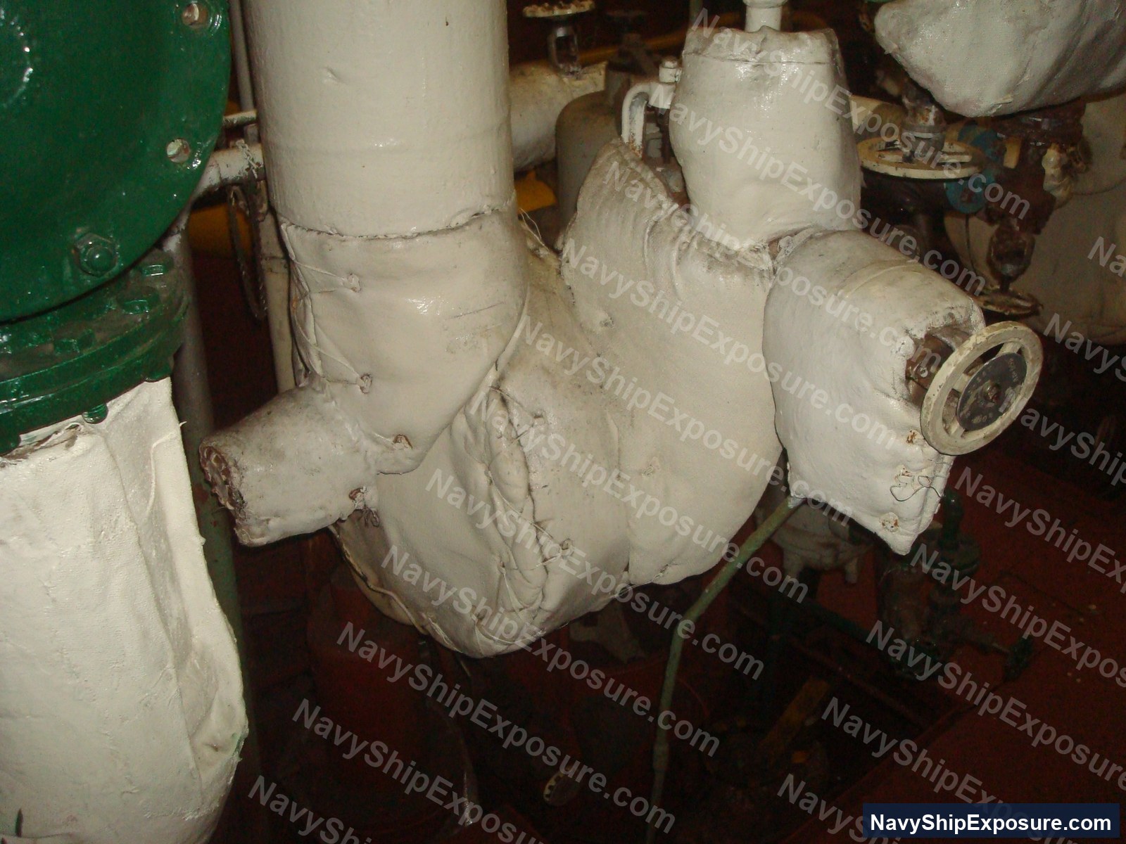 USS Midway — Insulated piping in an engine room or machinery space of USS Midway (CV-41), showing white thermal insulation wrapping typical of naval propulsion systems from the 1945-1992 era.
