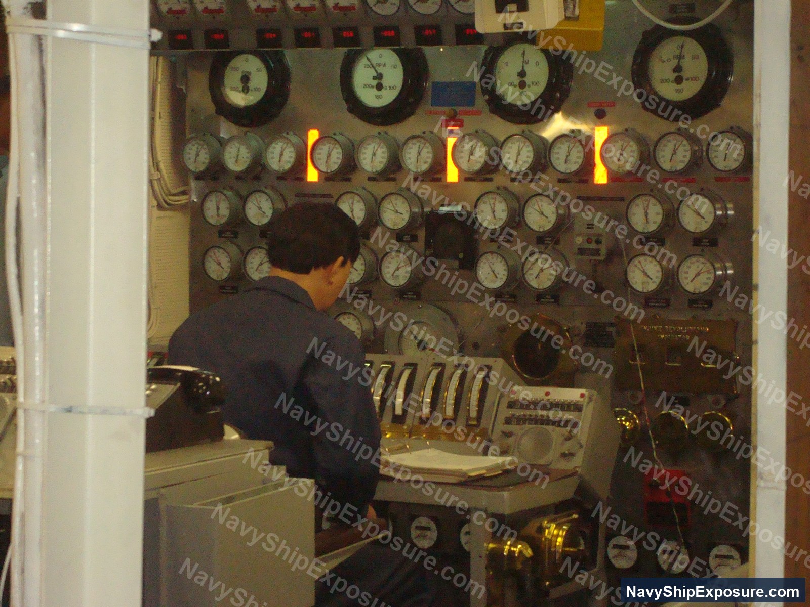 USS Midway — Engine room or machinery control space aboard USS Midway showing numerous analog gauges and monitoring instruments typical of 1945-1992 era naval vessel propulsion systems.